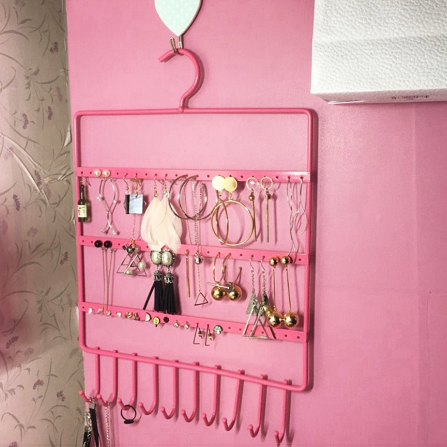 Wall-mounted earrings organizer with hooks