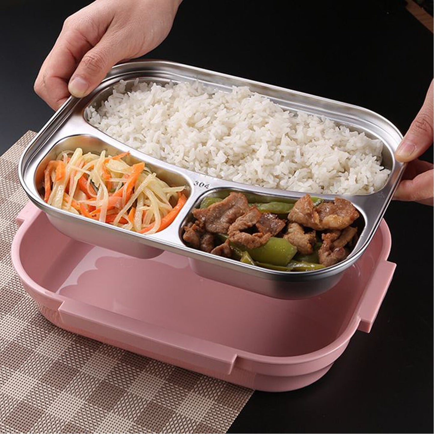 Three-compartment pink lunch box with spoon slot, made from stainless steel