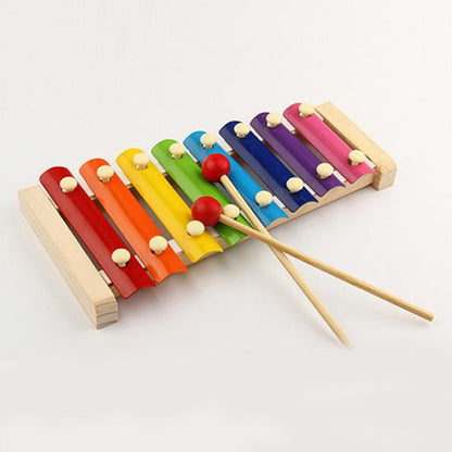 Xylophone with mallet on a white background, highlighting the wooden design